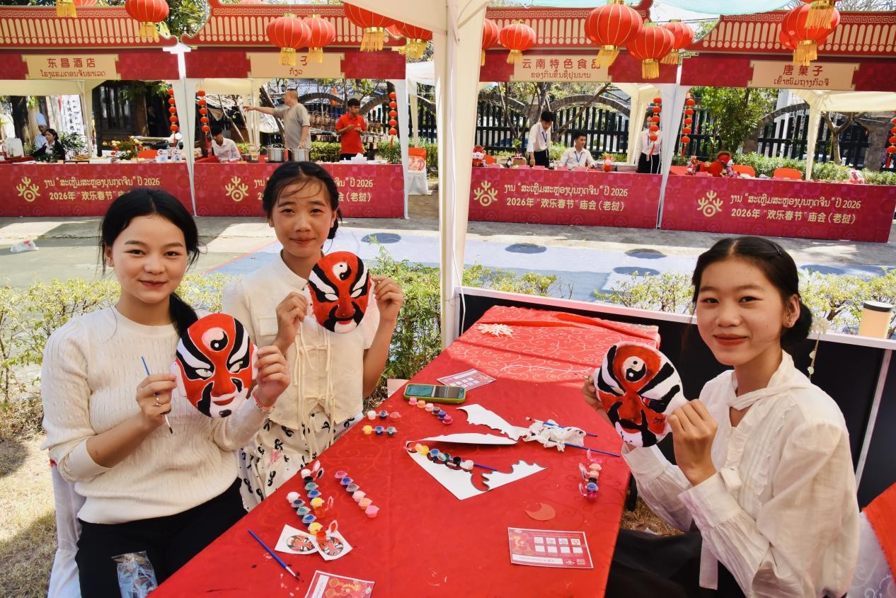 当地学生在庙会现场体验画脸谱。苏朋摄