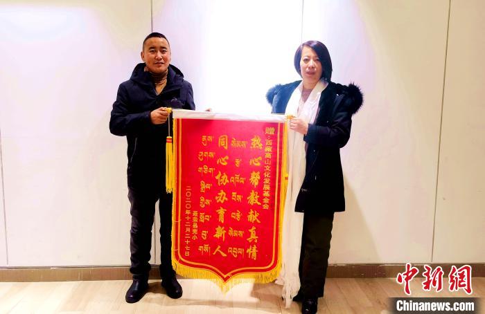 图为聂荣县完全小学向西藏高山文化发展基金会赠送锦旗。　于宾 摄