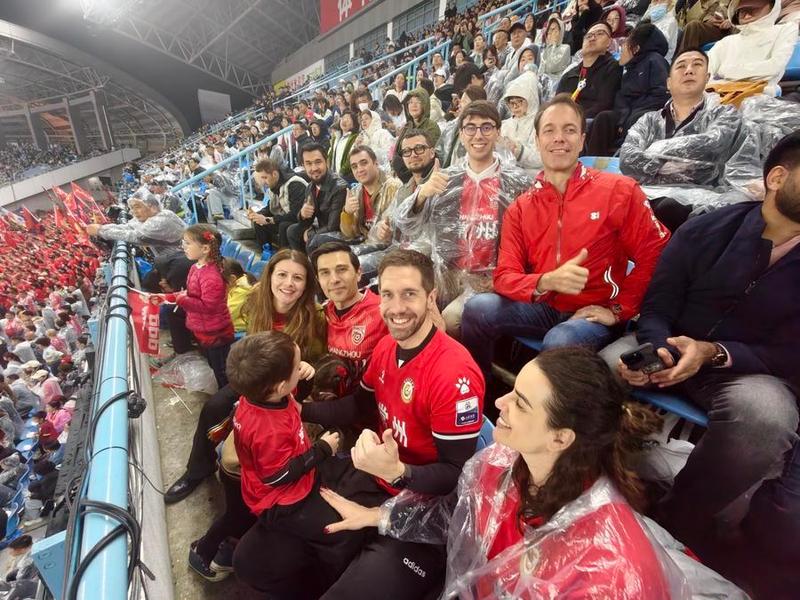 Carlos Lorite watches the opening match of Su Super League with his family and friends, April 11, 2026. Xinhua