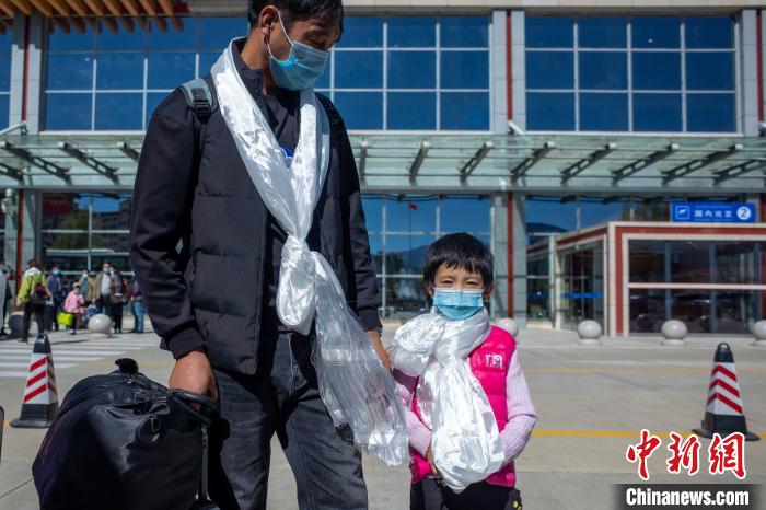 孩子和家长一起走出日喀则和平机场。　江飞波 摄