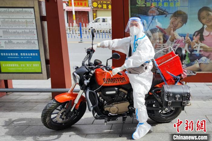 图为西藏阜康医疗工作人员骑摩托为居家防疫市民送药。　受访者供图
