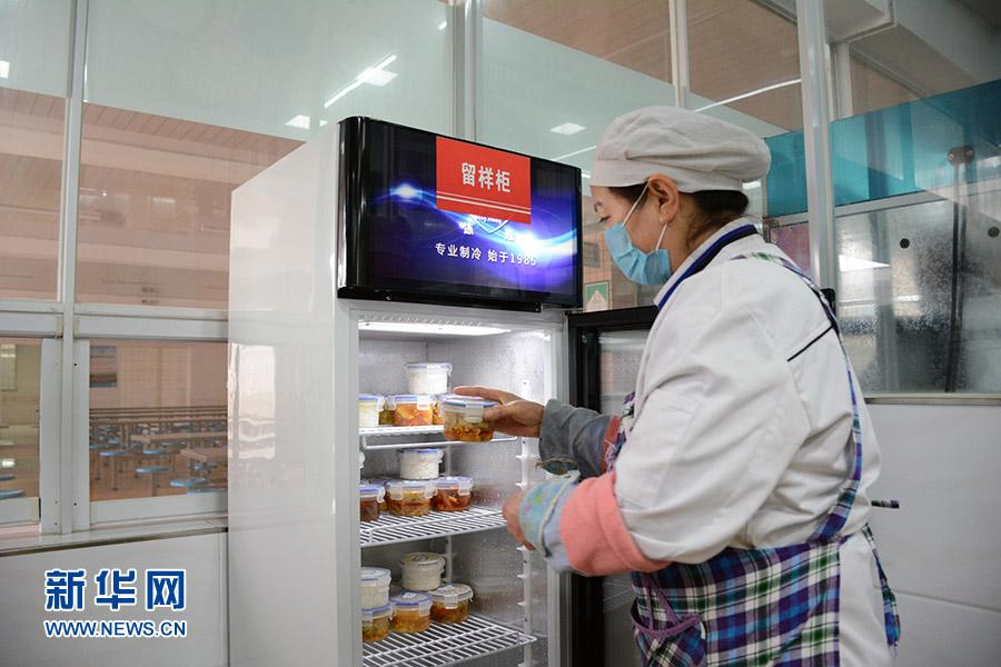 1月3日，重庆南川区北固中学食堂工作人员将食品留样放入冰柜中。新华网赵紫东 摄
